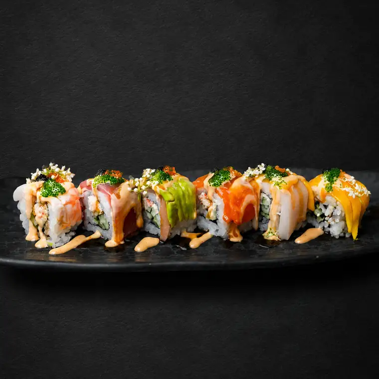Rainbow Roll — Crab Salad, Avocado, Kyuri, Wrapped with Mix Fish Avocado, Mango, Topped with Trio Tobiko, Chilli Mayonnaise & Eel Sauce. ENSO Japanese Fusion & Bar, Canggu, Bali.